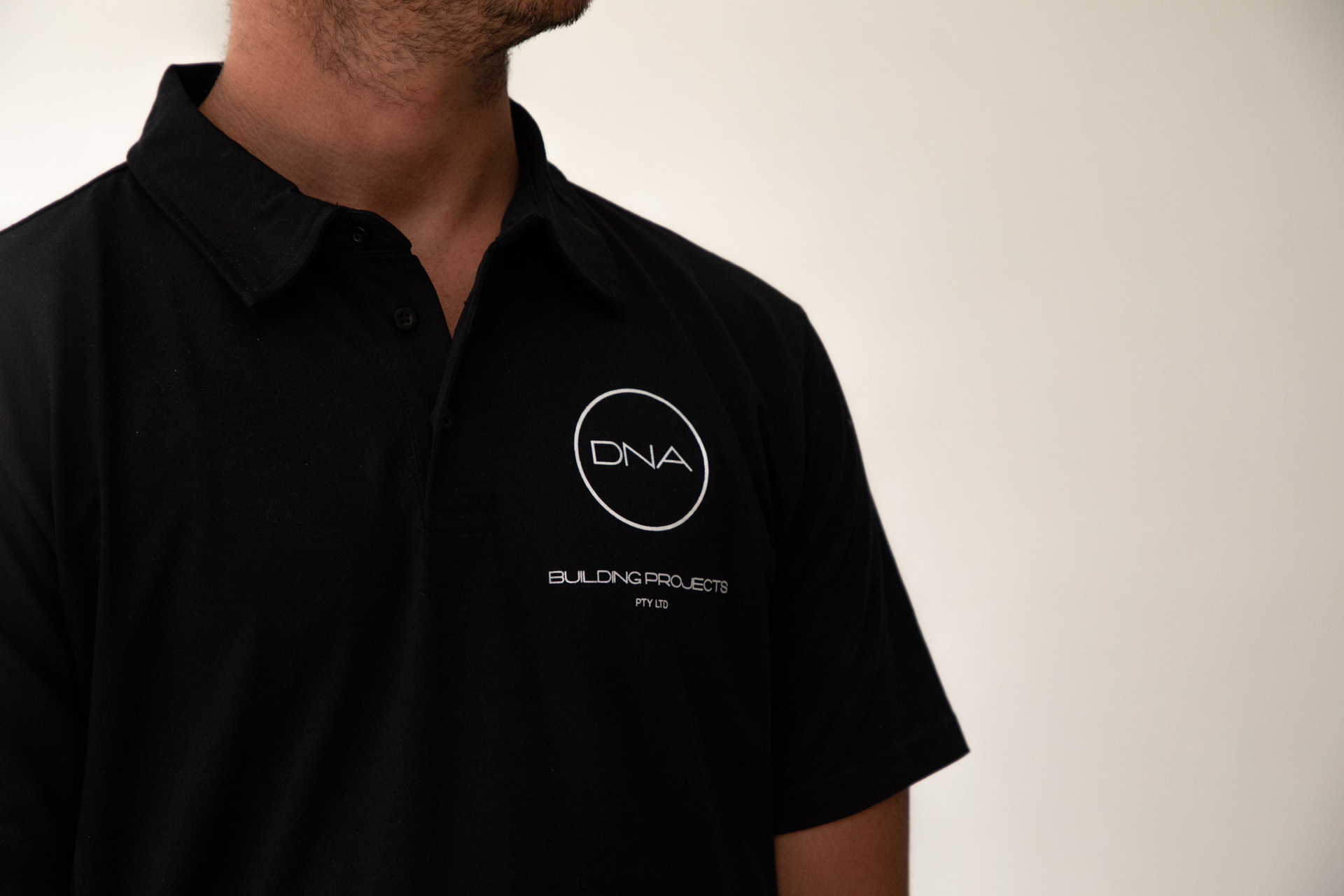 DNA building projects logo on a black tshirt